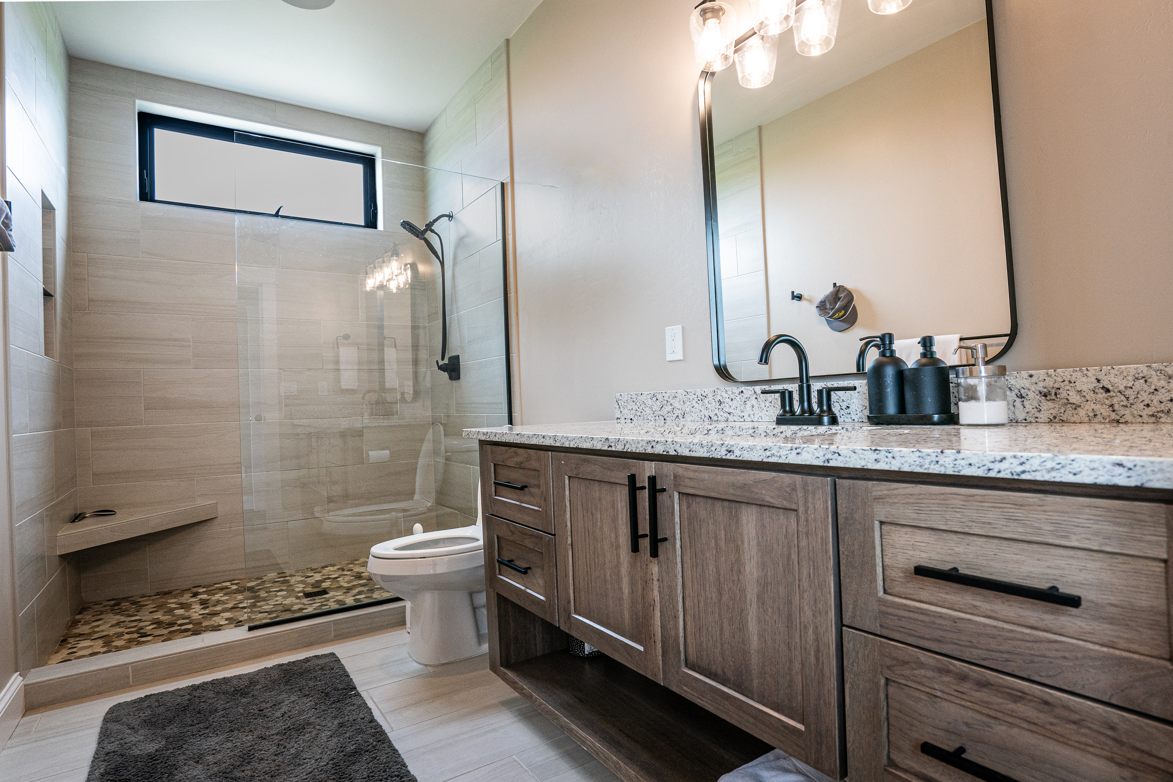 Bathroom with walk-in shower and double vanity at 3 Mile Cabin