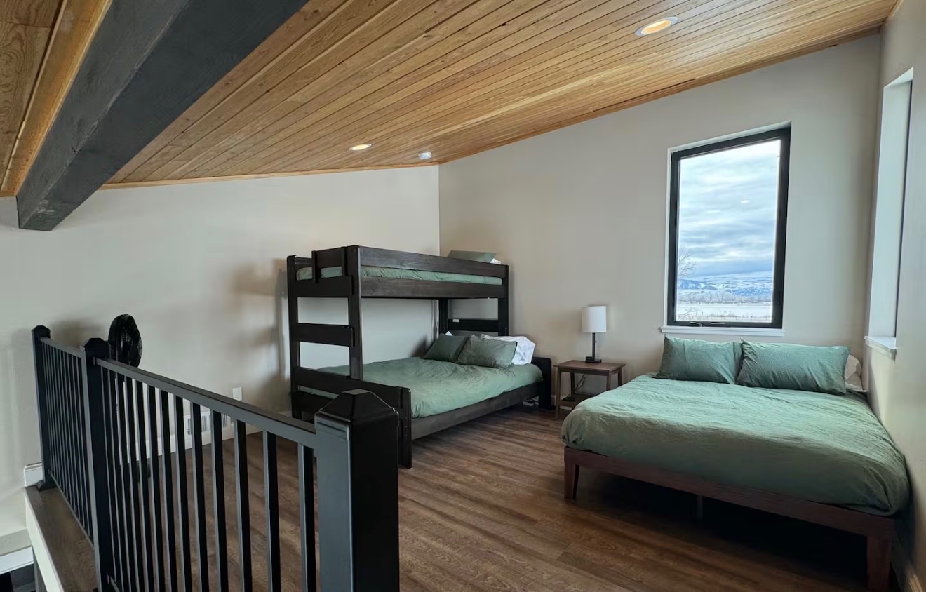 Loft with bunk bed and queen bed at 3 Mile Cabin