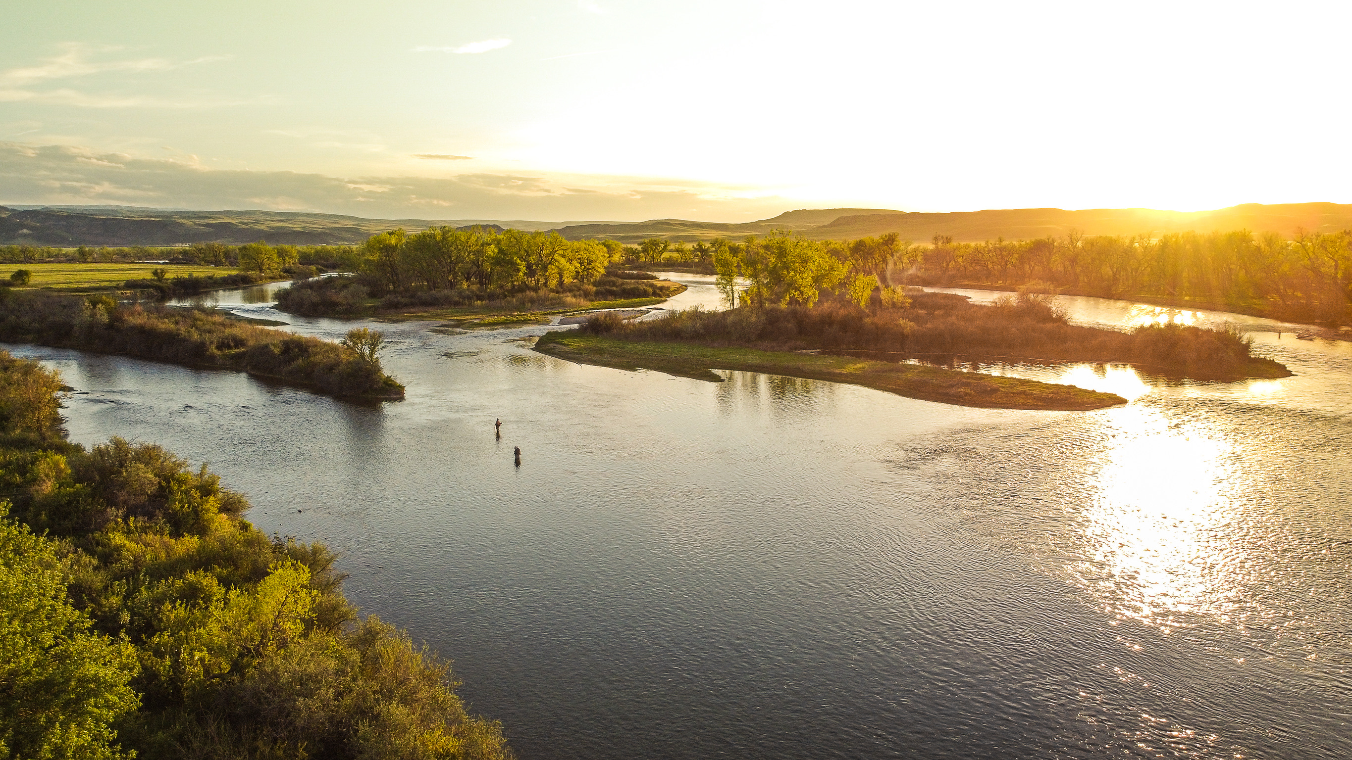 Aerial of an angler wading the Bighorn River at sunset near 3 Mile Cabin